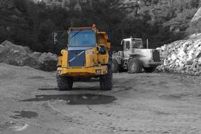 photo of two trucks at a construction site