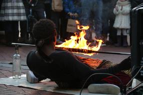 street performer with fire at dusk