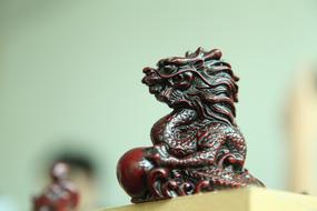 a wooden sculpture of a dragon made of mahogany