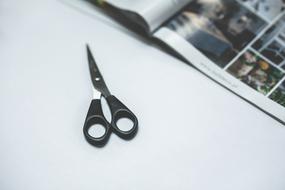 black scissors near the magazine