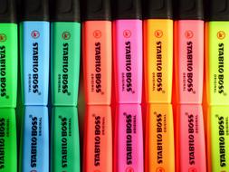 Colorful highlighters in row, with reflections