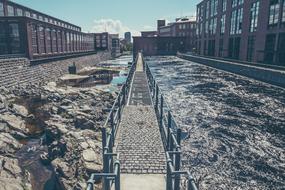 Bridge, among the rocks and water, among the buildings