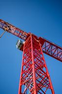 red industrial crane on blue sky background