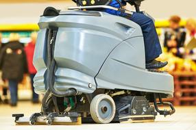 Person, on the floor cleaner machine, in the store