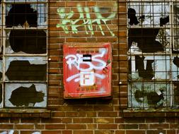 broken windows and graffiti on abandoned Factory building