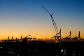 industrial cranes in the harbor at night