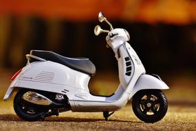 Vespa Roller as a miniature model on a blurred background