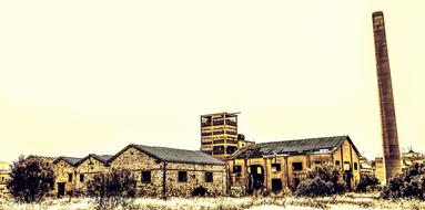 Beautiful landscape with the factory, among the trees and fields