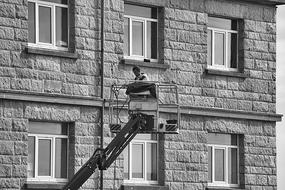 Man in Work Nacelle near the front of the house