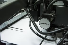 Close-up of the shiny, black headphones on the paper of printer