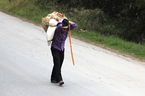 Colombian peasant with stuff, on the road, among the beautiful green plants