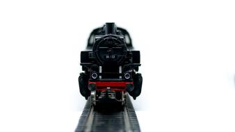 black steam locomotive on railway model