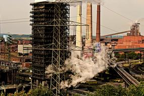 steam from an industrial plant in the afternoon