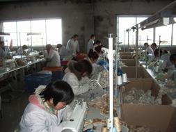 people are doing sewing in the factory