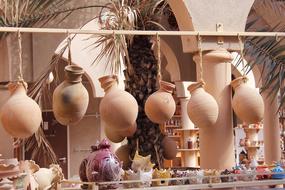 Beautiful and colorful pottery on the market, near the arches and palm tree