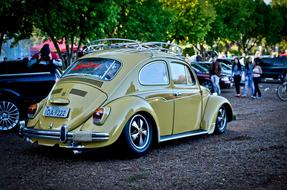 yellow volkswagen beetle on city street