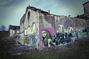 colorful graffiti on industrial ruins in the field