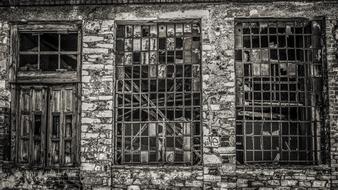 Black and white photo of the old, brick factory with broken windows