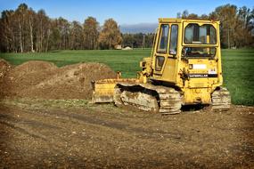 bulldozer works on road in countryside