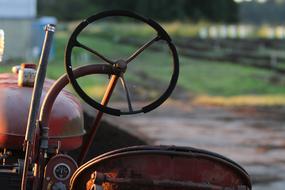 retro tractor on farm close up in blurred background