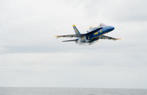 plane of blue angels in the sky above the water