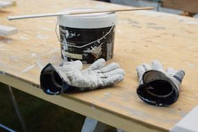 gloves and a can of paint on the table