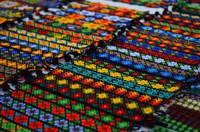 Many colorful, beautiful patterned bracelets in the rows