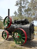 antique steam engine on wheels in nature