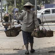 A man walks along the road in laos