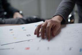 Hand on the papers with colorful signs