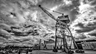 Black and white photo of the port of Portimao, Portugal, with the crane