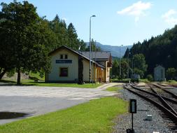 Beautiful landscape with the railway station, near the railway, among the beautiful green trees