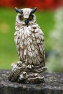 sculpture in the form of an owl on a blurred background