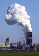 Cooling tower of the factory, with smoke, in Duisburg, Germany