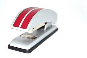 white stapler with red stripes