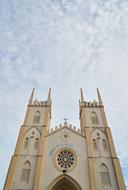 old temple building under blue sky with clouds