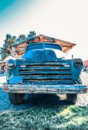old blue truck on a sunny day