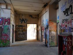 Old building, with the colorful graffities, in light and shadow