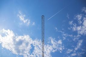 distant view of industrial crane against bright blue sky