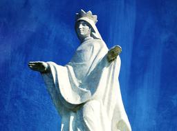 sculpture of St. Mary on a blue background
