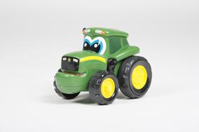 Colorful, shiny tractor toy with the face