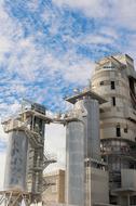 sky with white clouds over industrial architecture