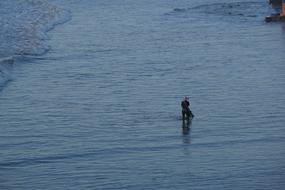 Worker in the beautiful, blue water with ripple