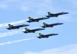 Beautiful, flying "Blue Angels" with white contrails, in the beautiful blue sky with white clouds