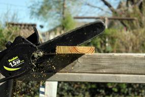 Chain Saw Cutting Action close-up on blurred background