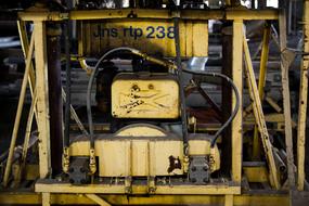 Yellow and black machinery, with the numbers and sign, in light