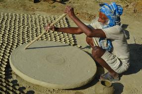 Old Man Working with Pottery In Village