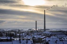 Beautiful winter landscape with the city in snow, at colorful sunrise