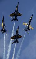 Beautiful, flying "Blue Angels" with white contrails, in the blue sky