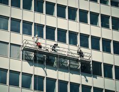 washing windows on the facade of a high-rise building